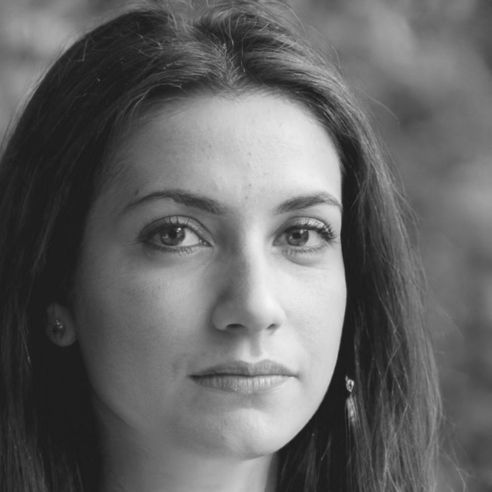 Professional woman in consultation setting explaining financial concepts with documents and charts