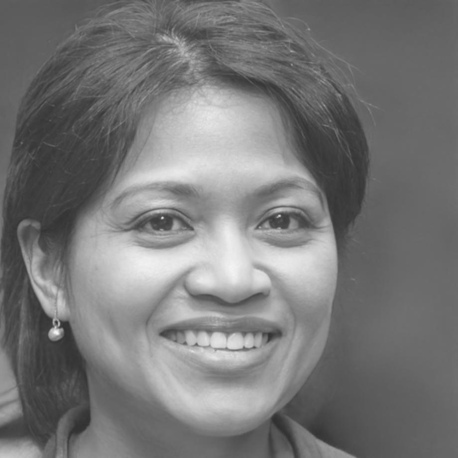 Professional woman in business attire smiling confidently in modern office setting